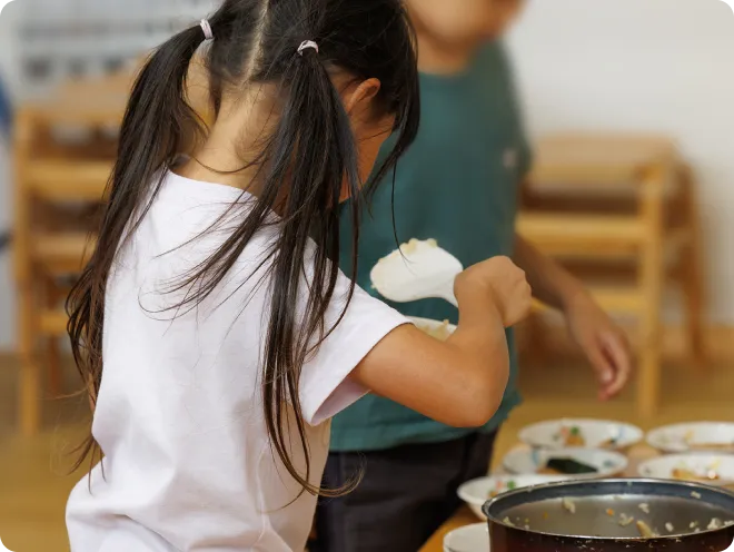 子どもがごはんをよそっている画像